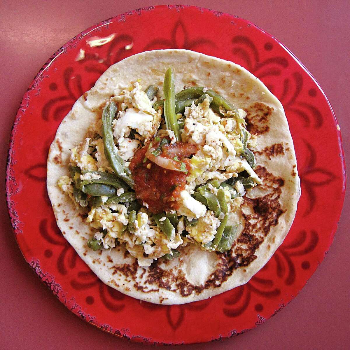 Nopales and egg taco on a handmade flour tortilla from La Cavaña Mexican Restaurant.