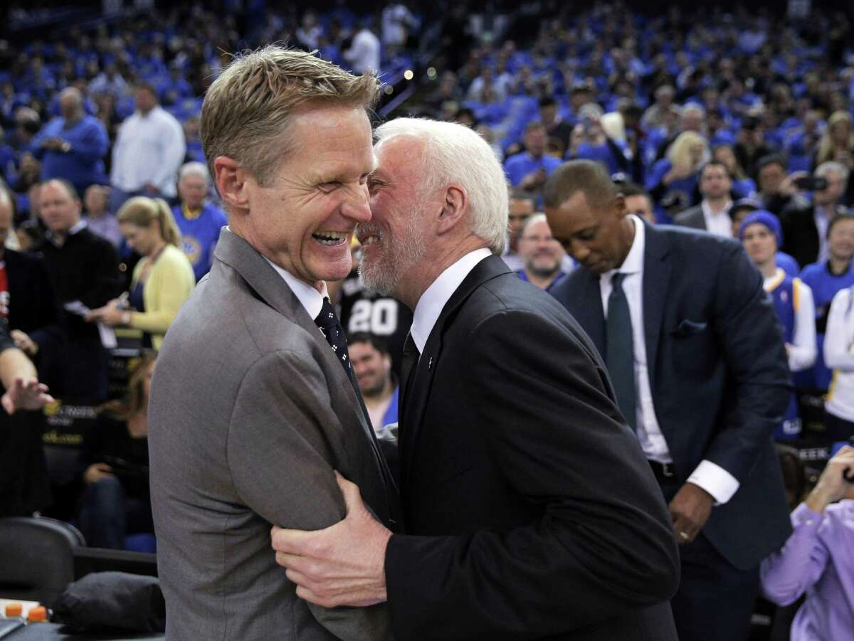 Warriors coach Steve Kerr shares a moment with Spurs coach Gregg Popovich before the game at Oracle Arena in Oakland, Calif., on Jan. 25, 2016.