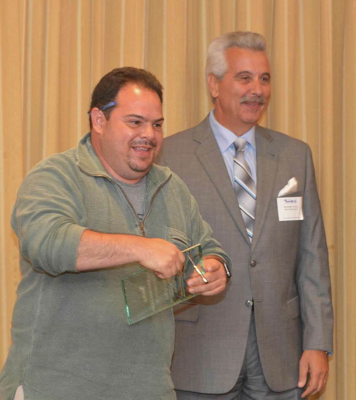 Luis Solis, owner of Norwalk Pizza and Pasta and Don Carmelos accepts the Restauratuer of the Year Award during the Greater Norwalk Chamber of Commerce 2017 Small Business Awards on Wednesday June 7, 2017 at the Norwalk Inn, in Norwalk Conn.