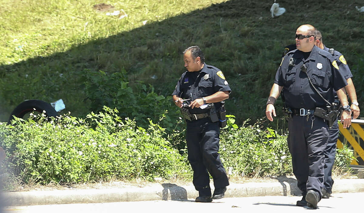 Houston Police Department officers investigate the scene where a mowing crew found a motorcycle and a badly decomposed body near the feeder road of U.S. 59 North, just south of Loop 610. Police said the crash likely was an accident.