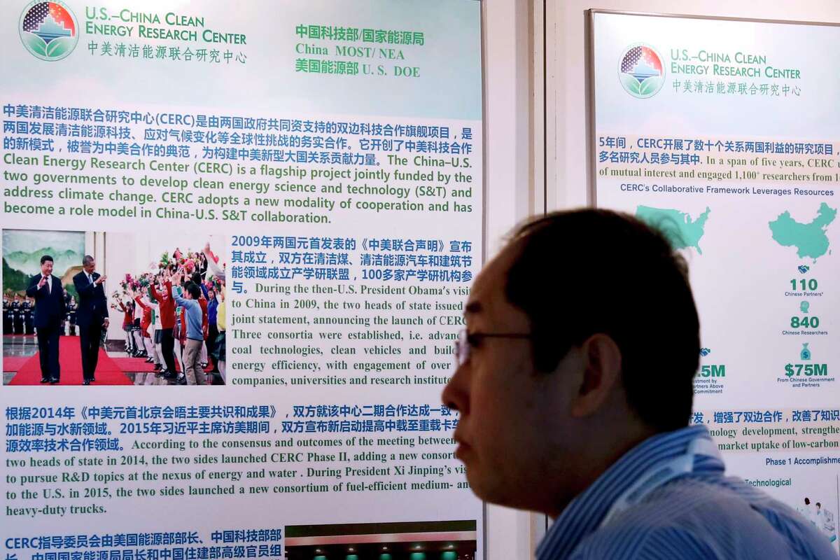 A man visits to the China-U.S. Clean Energy Research Center exhibition booth on display during the China Clean Energy Ministerial conference in Beijing, Thursday, June 8, 2017. America and China have "extraordinary opportunities" to work together on clean energy, U.S. Energy Secretary Rick Perry said Thursday, amid global criticism of President Donald Trump's decision to pull the U.S. out of the Paris climate agreement. (AP Photo/Andy Wong)