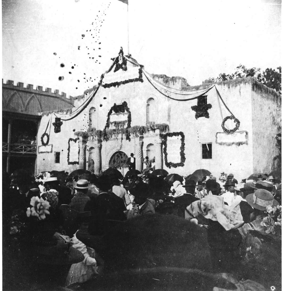 Celebration in front of a decorated Alamo in the 1890s.