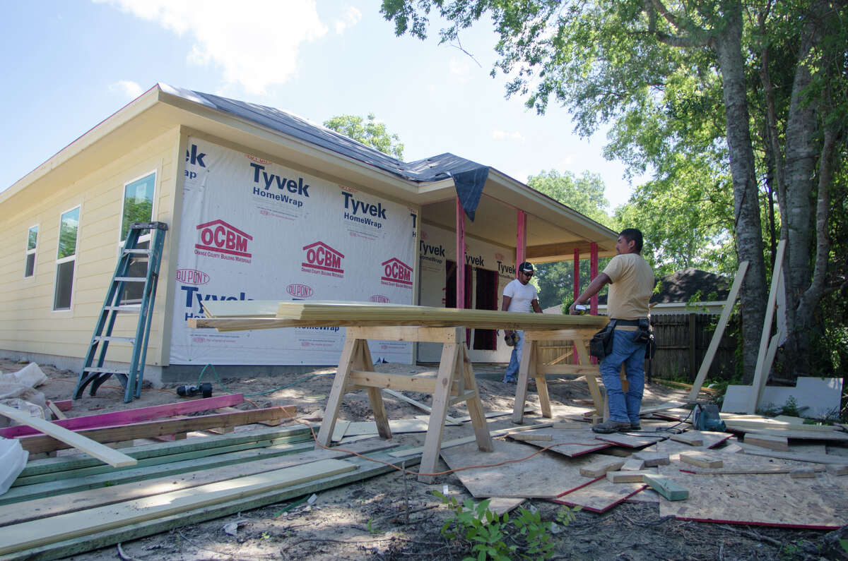 A construction crew works on a house in Sour Lake. The small town of just under 2,000 has seen a small boom in its population in the past two years.