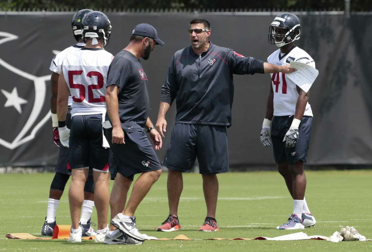 Texans defensive coordinator Mike Vrabel works with the linebackers during OTAs at the Methodist Training Center on June 6, 2017, in Houston.