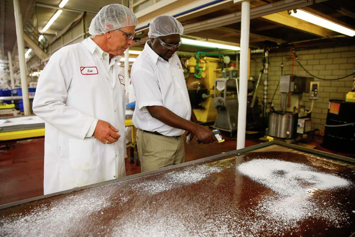 Atkinson Candy Company president Eric Atkinson, left, looks at workers making caramel during a tour of Atkinson Candy Company Wednesday, May 17, 2017 in Lufkin. ( Michael Ciaglo / Houston Chronicle )