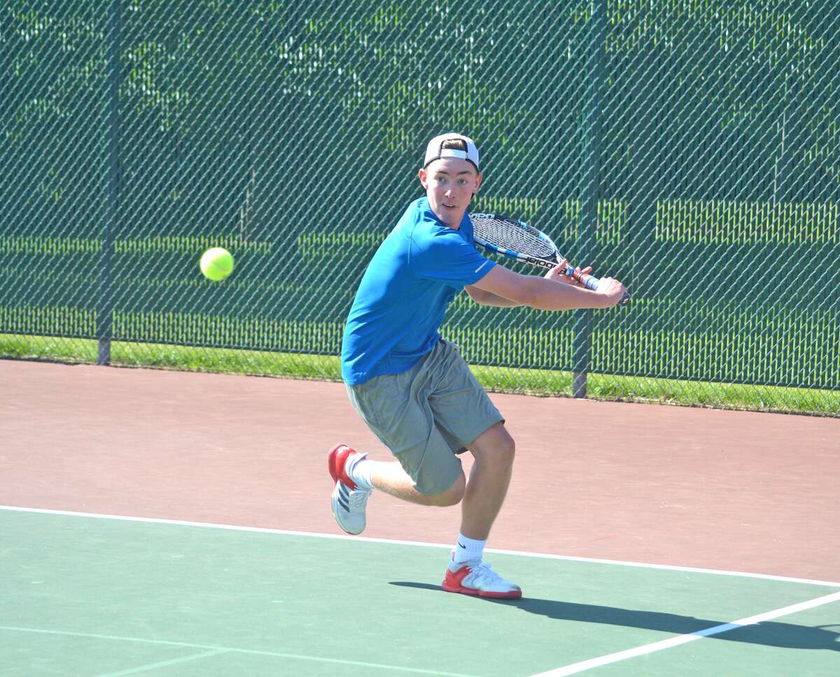Logan Pursell, who will be a senior at Edwardsville, makes a backhand return during a first-round match on Friday in men’s open singles at the Edwardsville Open.