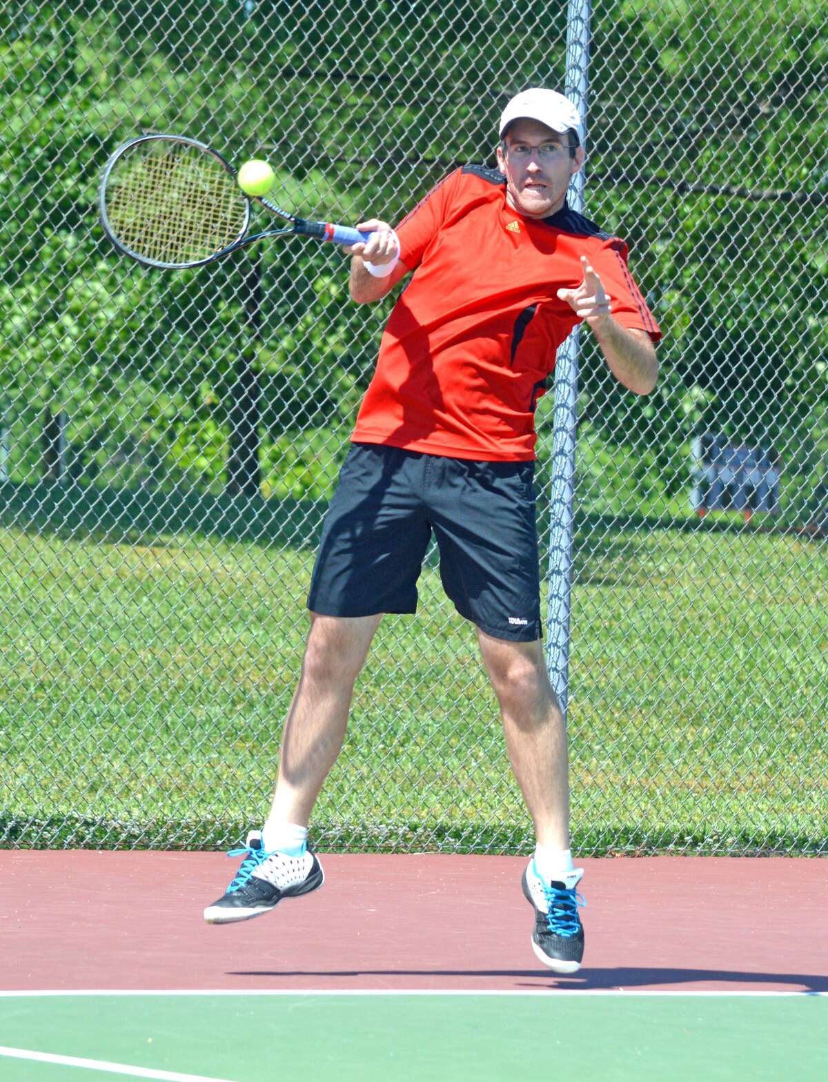 Kirk Schlueter, a 2010 EHS graduate, hits a forehand during his first-round match.