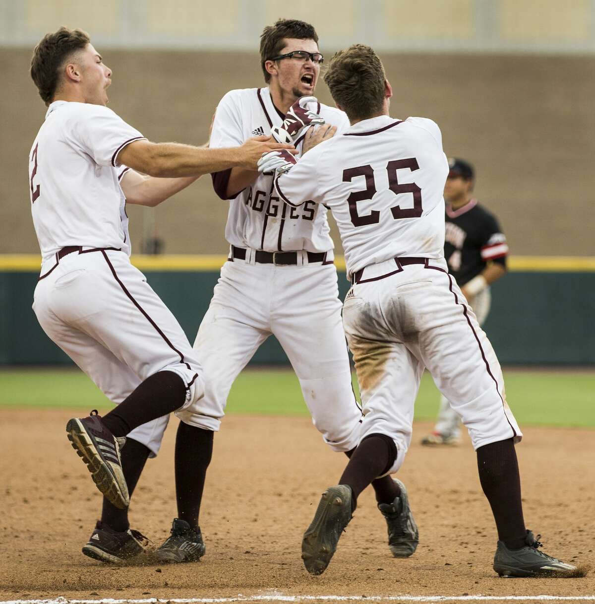 Texas A&M's George Janca, center, Tim Lichty (2) and Austin Homan (25) celebrate Janca's RBI walk off single off Davidson reliever Westin Whitmire for a 7-6 win in 15 innings during the NCAA baseball Super Regional at Olsen Field at Blue Bell Park on Friday, June 9, 2017, in College Station. ( Brett Coomer / Houston Chronicle )