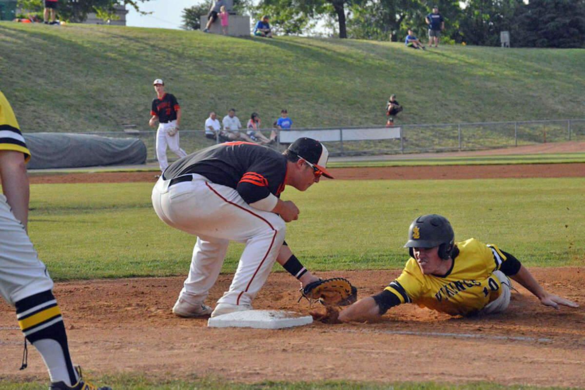 Edwardsville first baseman Drake Westcott tags out St. Laurence’s Matt McCormick on a pick-off in the first inning.