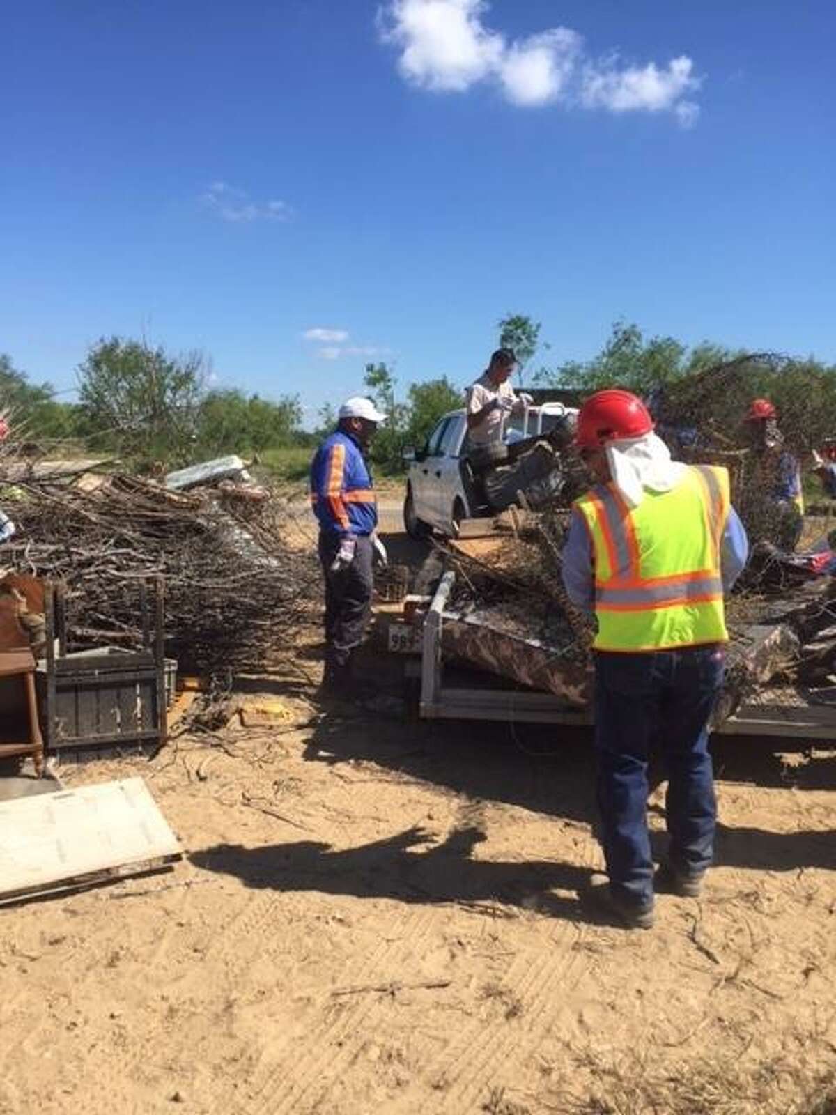 More than 30 Webb County employees and community volunteers assist El Cenizo residents in picking up and disposing of unwanted items on Tuesday.
