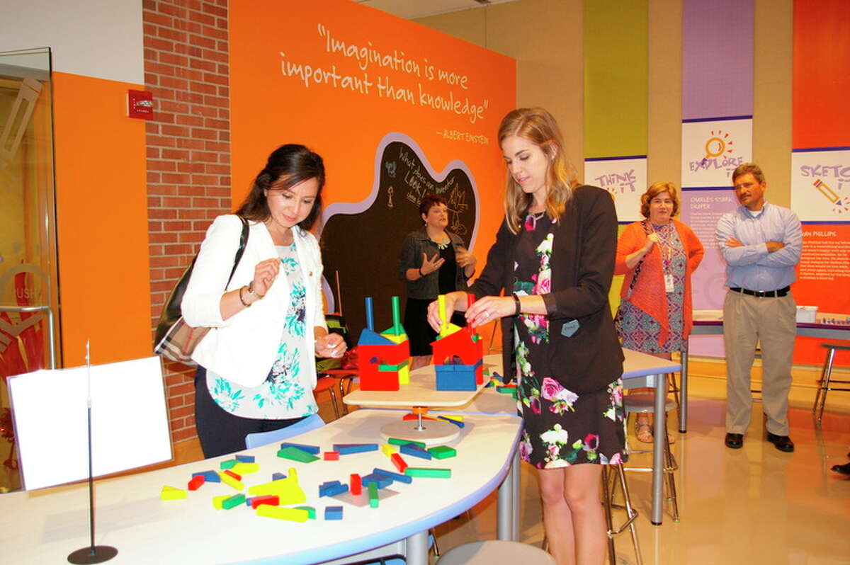 Before the ribbon-cutting ceremony for the Spark!Lab Smithsonian Friday afternoon, Lucy Pagán of Midland and Megan Manning of Bay City succeeded at the Towering Teeter Table Challenge. Pagán and Manning represented the DeVos Graduate School at Northwood University at the event.