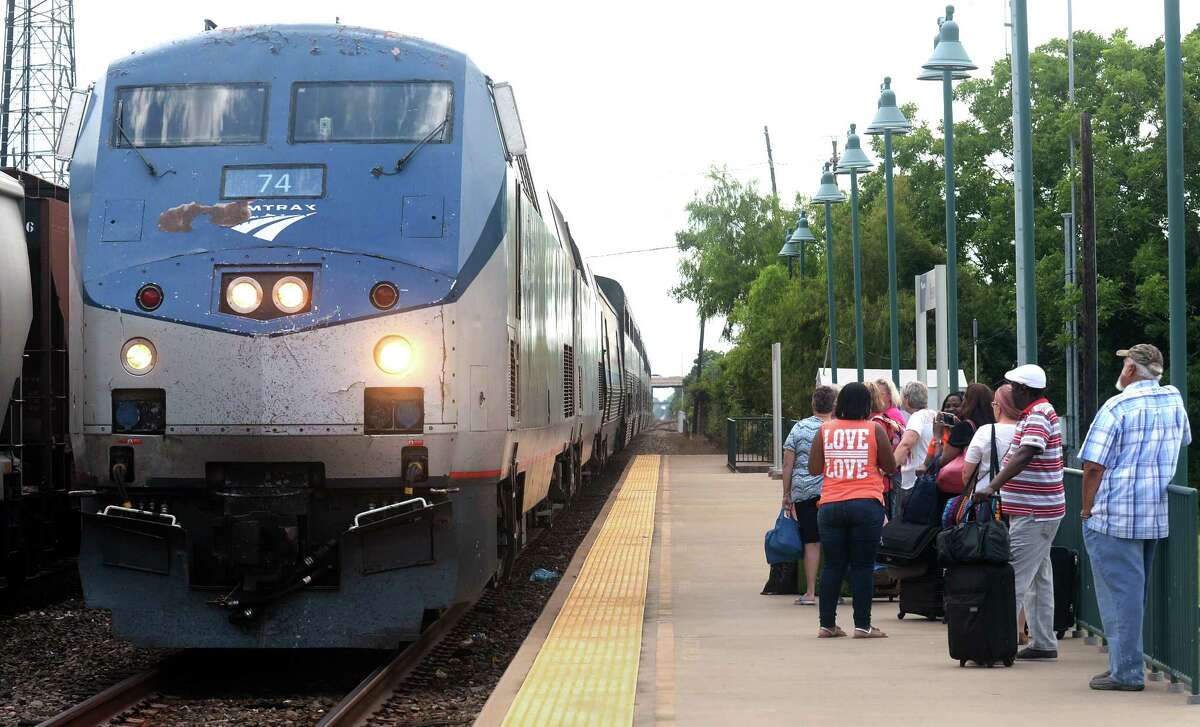 Travelers watch an Amtrak train arrive at the Beaumont train station on Friday. Proposed budget cuts from President Trump could effect Amtrak routes. Photo taken Friday, June 09, 2017 Guiseppe Barranco/The Enterprise