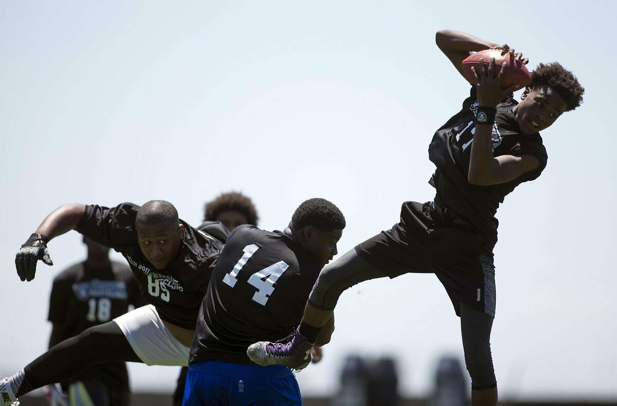 Oakland Athletic League prep football players participate in drills at a defensive drills clinic run by Oakland Raiders defensive coordinator Ken Norton, Saturday, June 10, 2017, at the Raiders' headquarters in Alameda, Calif.