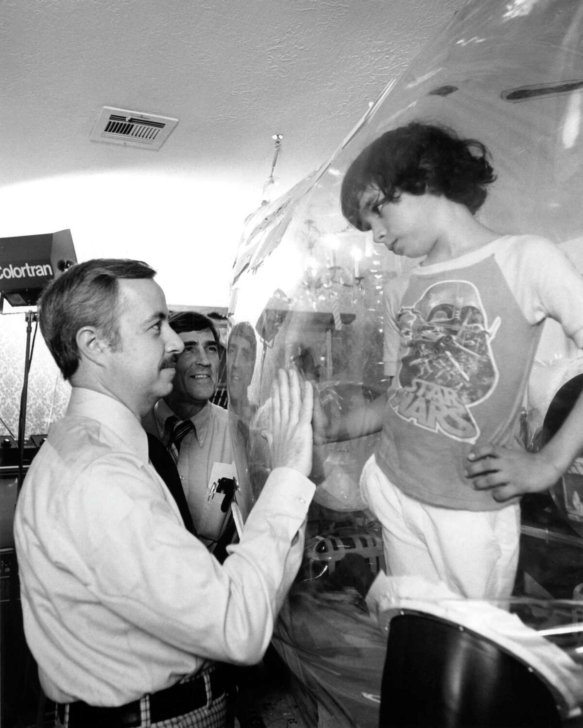 Dr. William Shearer visits with his patient, "Bubble Boy" David Vetter, at Texas Children's Hospital in 1979. David died in 1984 at age 12.