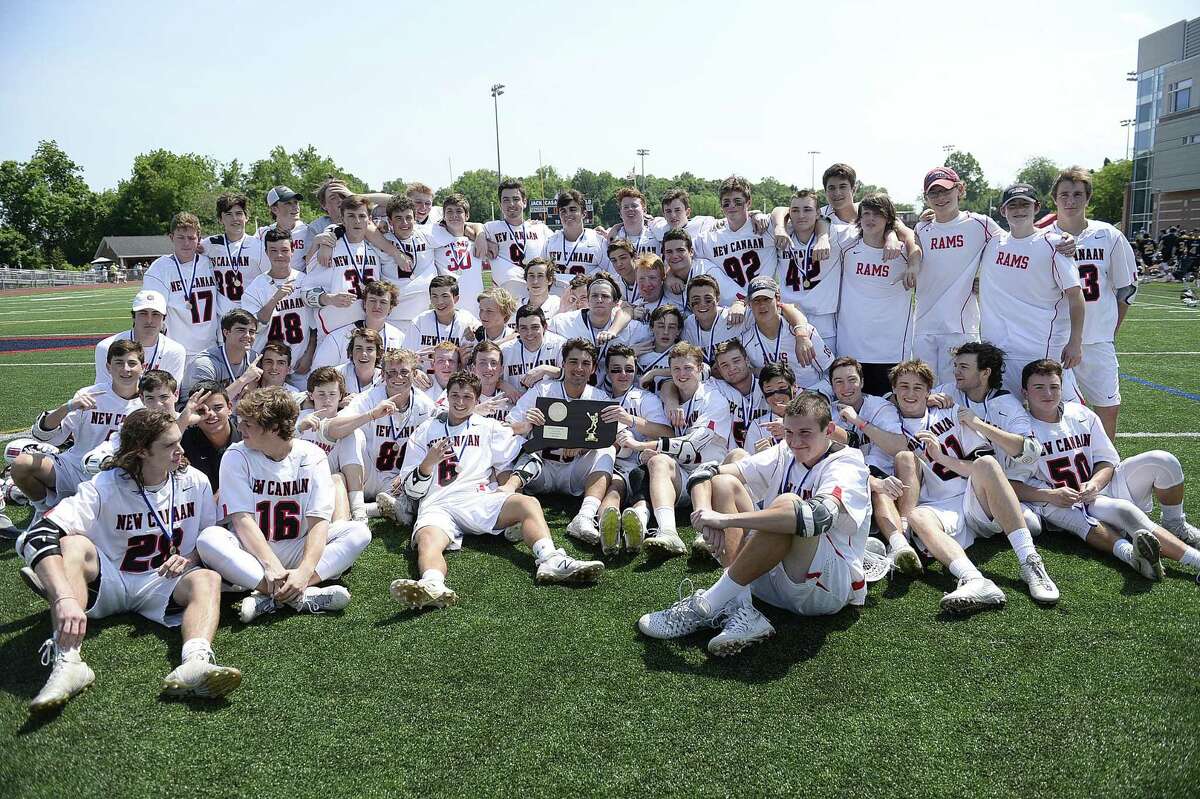 The New Canaan lacrosse team poses for a photo after winning Saturday's Class M Boys Lacrosse final between Daniel Hand and New Canaan at Brien McMahon High School in Norwalk, Conn., on Saturday, June 10, 2017.