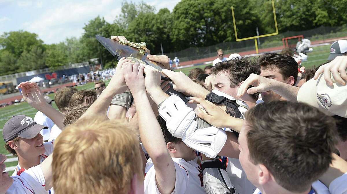 The New Canaan lacrosse team celebrates after winning Saturday's Class M Boys Lacrosse final between Daniel Hand and New Canaan at Brien McMahon High School in Norwalk, Conn., on Saturday, June 10, 2017.