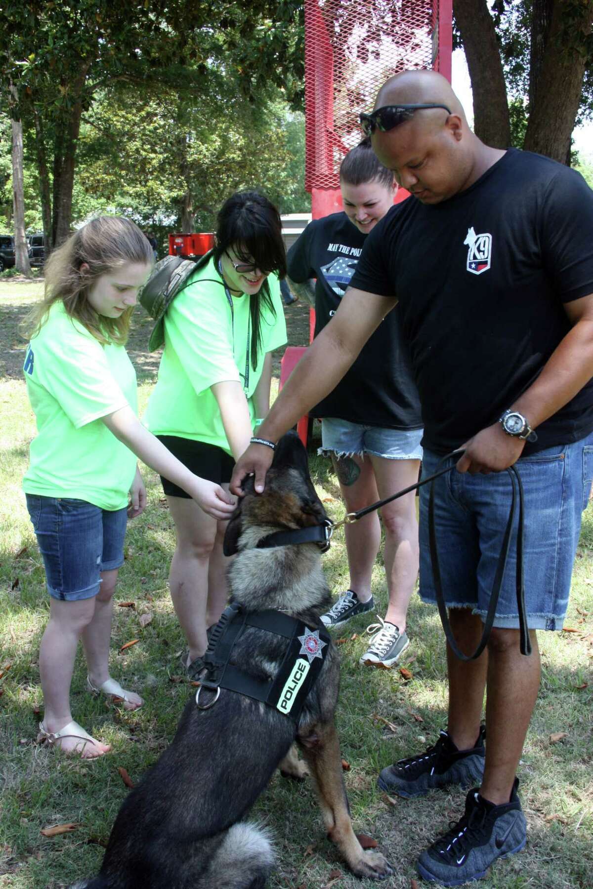 Michael St. Romaine, an officer with Splendora Police Department, brought about K-9 A.D., for the fundraiser for Roman Forest Police Chief Stephen Carlisle on Saturday at Trinity Armory in Cleveland. A.D. was a hit with adults and child, and gladly allowed them to pet him before moving on to the next group of people.