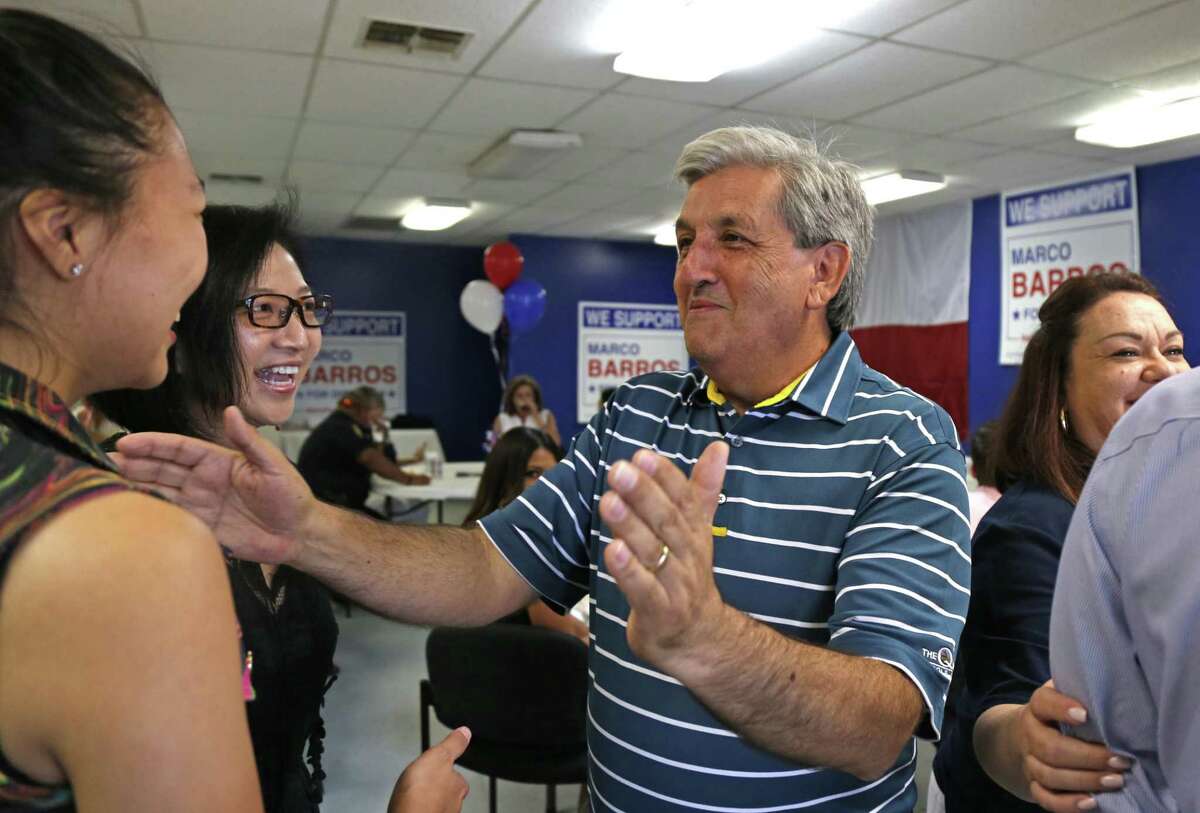 Marco Barros greets Nikola Hew,daughter to Councilwoman Elisa Chan,center. Marco Barros at his campaign office for District 9 at 15156 San Pedro on Saturday, May 10,2017.