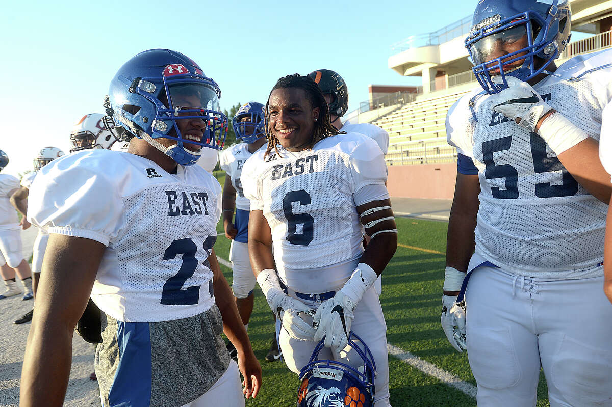 Members of the East team joke with one another as they take in the game action with West during the All Star football match-up at the Thomas Center Saturday night. Photo taken Saturday, June 10, 2017 Kim Brent/The Enterprise