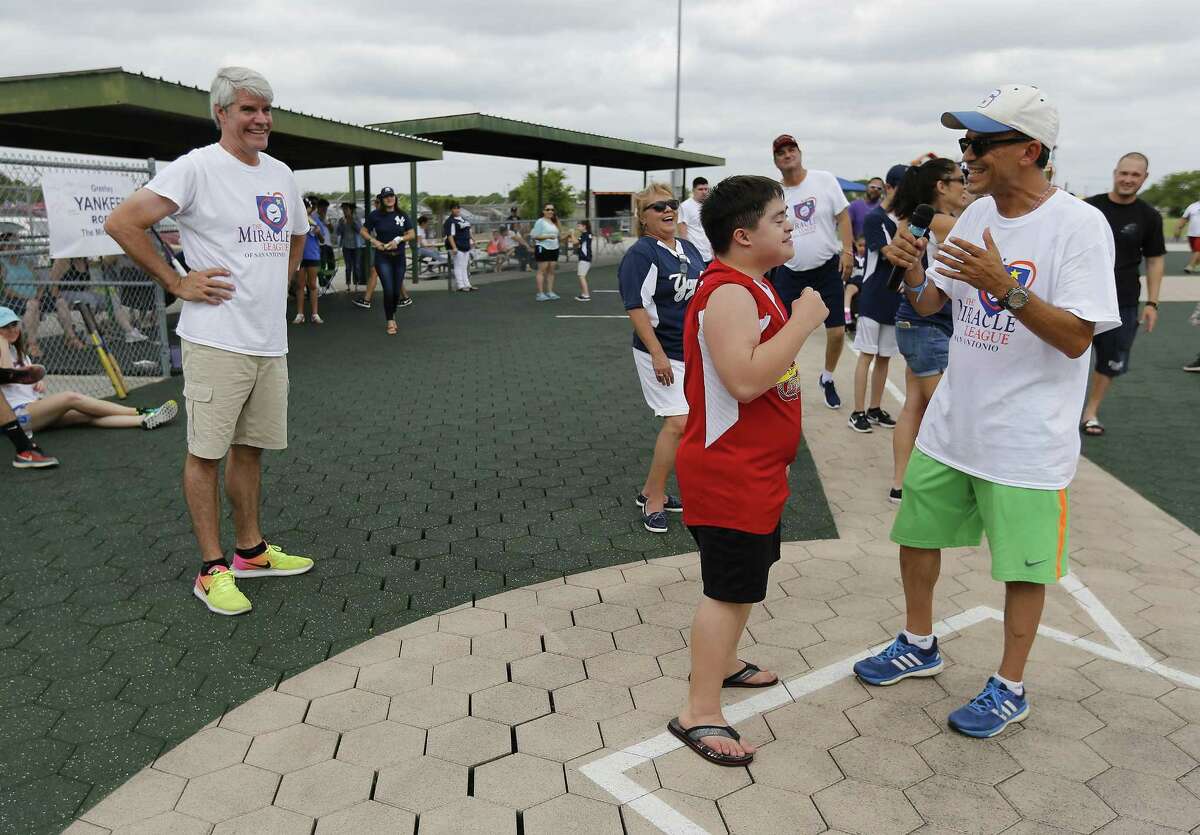 Miracle League of San Antonio founder Mike Miller (left) watches as Maury Vasquez (right) chats with one of the players a baseball game at the Miracle League of San Antonio on Saturday, June 10, 2017. The Miracle League of San Antonio gives special needs kids an opportunity to play the game of baseball in a supportive and fun environment. Six teams concluded their Spring season with each child getting a swing at bat with family and friends cheering them on. At the end, the children received trophies for their participation. (Kin Man Hui/San Antonio Express-News)
