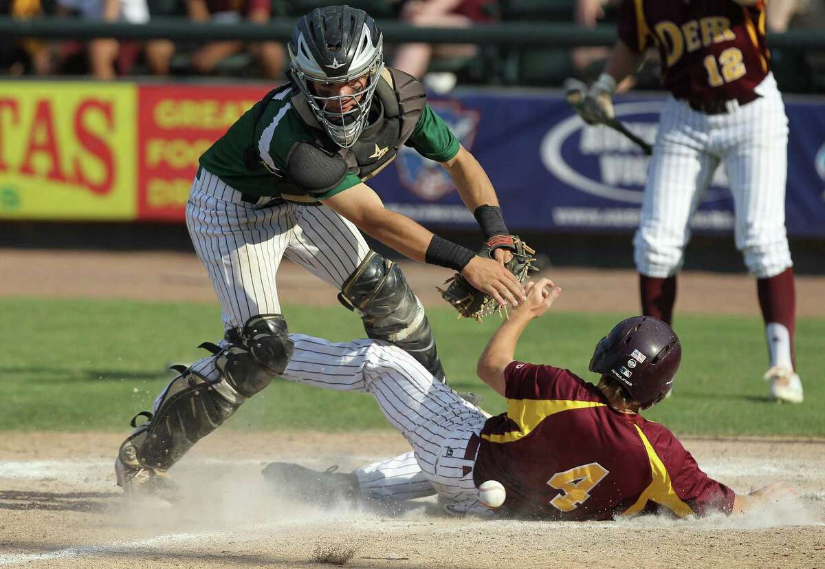 Deer Park's Tyler Stenberg (4) slides safely into him under Reagan's Mason Moore during a Class 6A UIL state championship at Dell Diamond in Round Rock, Saturday, June 10, 2017. (Stephen Spillman)