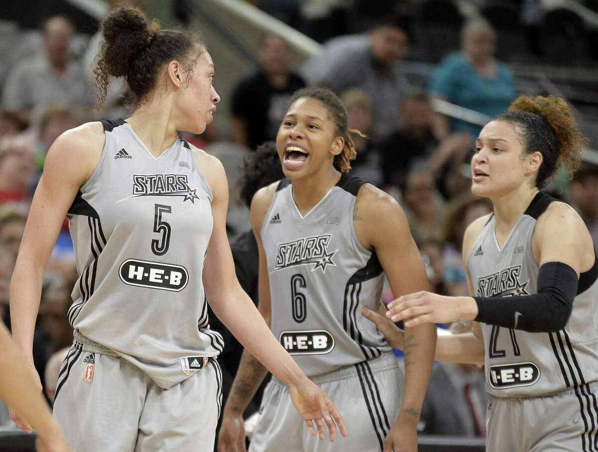Stars players (from left) Dearica Hamby, Alex Montgomery and Kayla McBride talk on the court during the second half against the Chicago Sky on June 10, 2017, in San Antonio.