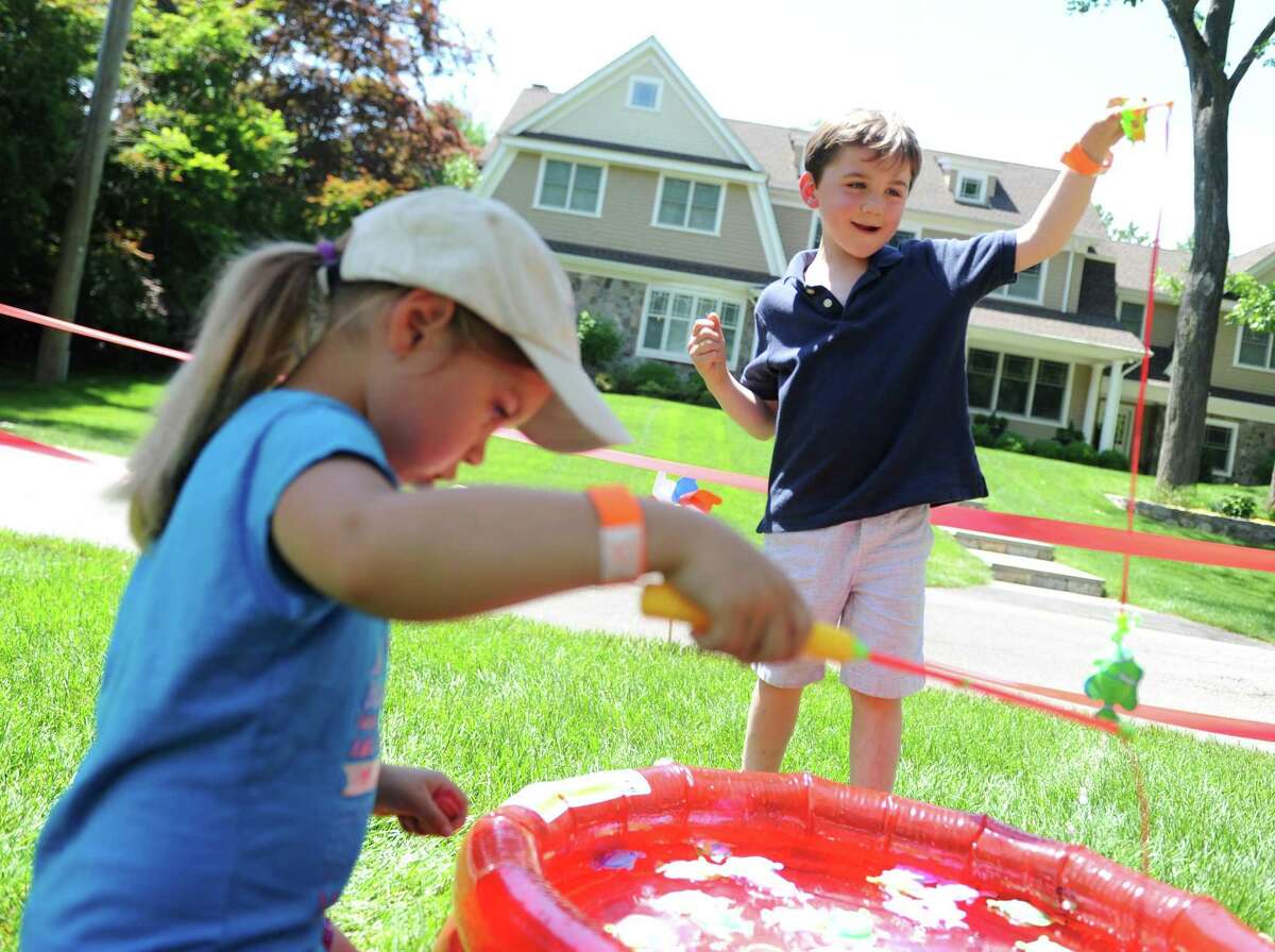 Greenwich kids Sidney Bellissimo, 6, and Anderson Weiner, 5, play a fishing game to win tickets at the fifth annual Jones Carnival for a Cause to benefit Abilis in Greenwich, Conn. Sunday, June 11, 2017. The carnival featured kids games, live music and a beer garden to benefit Abilis, a non-profit that provides services for special needs individuals in Fairfield County. The event is organized by Greenwich High School freshman Daniella Jones, who has an older brother with autism and a younger brother with a form of cerebral palsy.