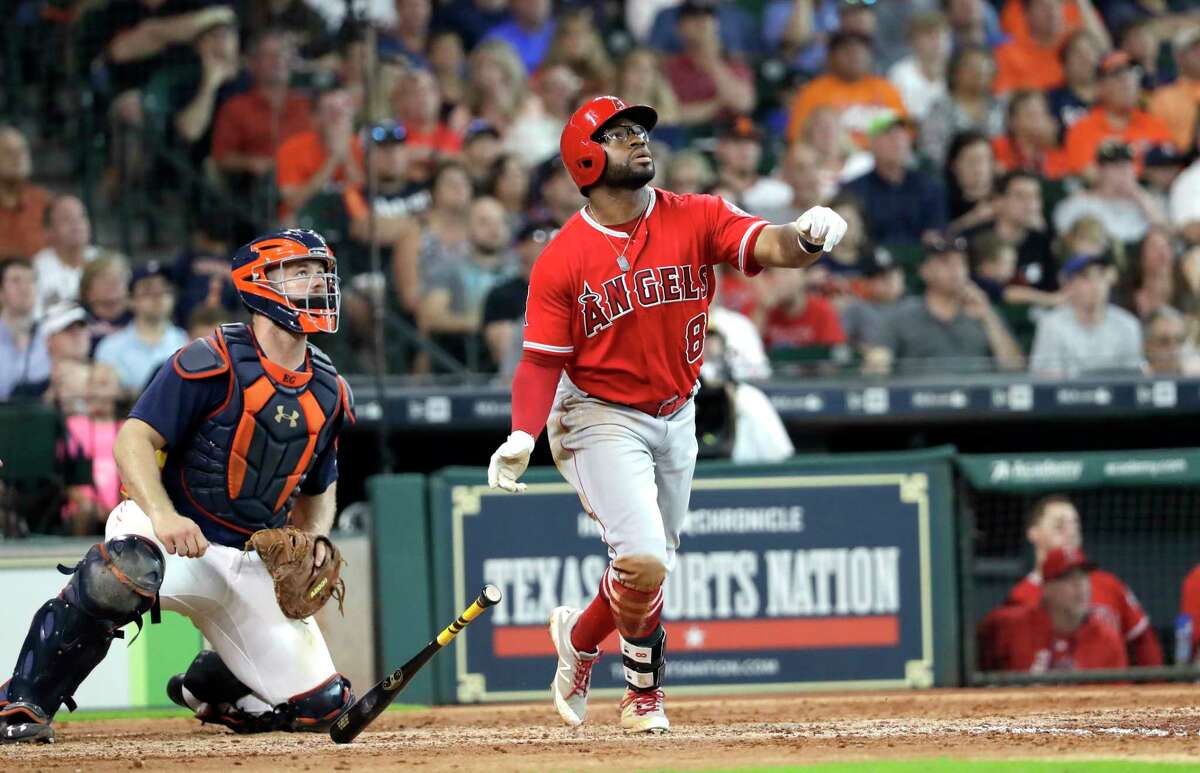 Los Angeles Angels' Eric Young Jr. (8) watches his three-run home run along with Houston Astros catcher Evan Gattis during the fifth inning of a baseball game, Sunday, June 11, 2017, in Houston. (AP Photo/David J. Phillip)