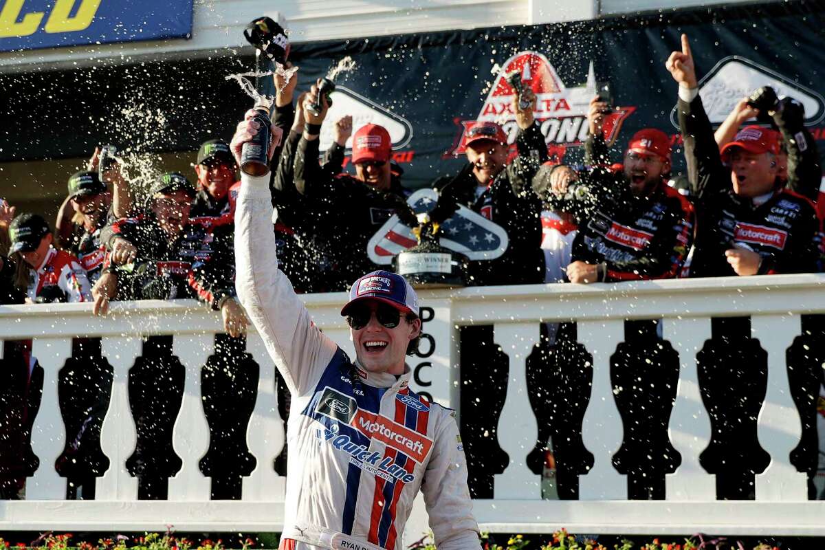Ryan Blaney celebrates in Victory Lane after winning the NASCAR Cup Series Pocono 400 auto race, Sunday, June 11, 2017, in Long Pond, Pa. (AP Photo/Matt Slocum)