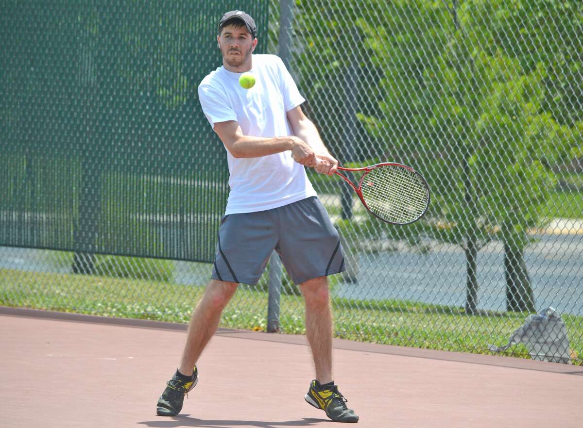 Cameron Randall, a 2012 Edwardsville High School graduate, makes a forehand return during his men’s open singles consolation final on Sunday at the Edwardsville Open.