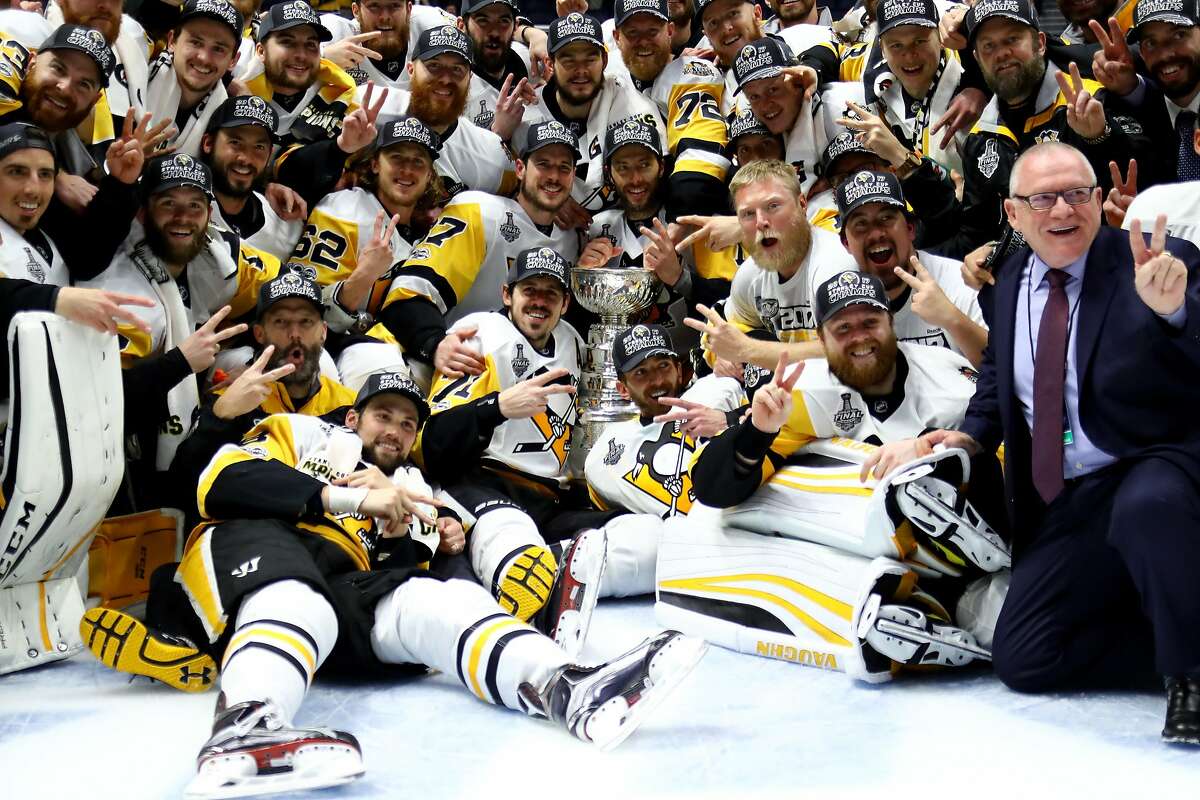 NASHVILLE, TN - JUNE 11: The Pittsburgh Penguins pose for a group photo with the Stanley Cup Trophy after they defeated the Nashville Predators 2-0 in Game Six of the 2017 NHL Stanley Cup Final at the Bridgestone Arena on June 11, 2017 in Nashville, Tennessee. (Photo by Bruce Bennett/Getty Images)
