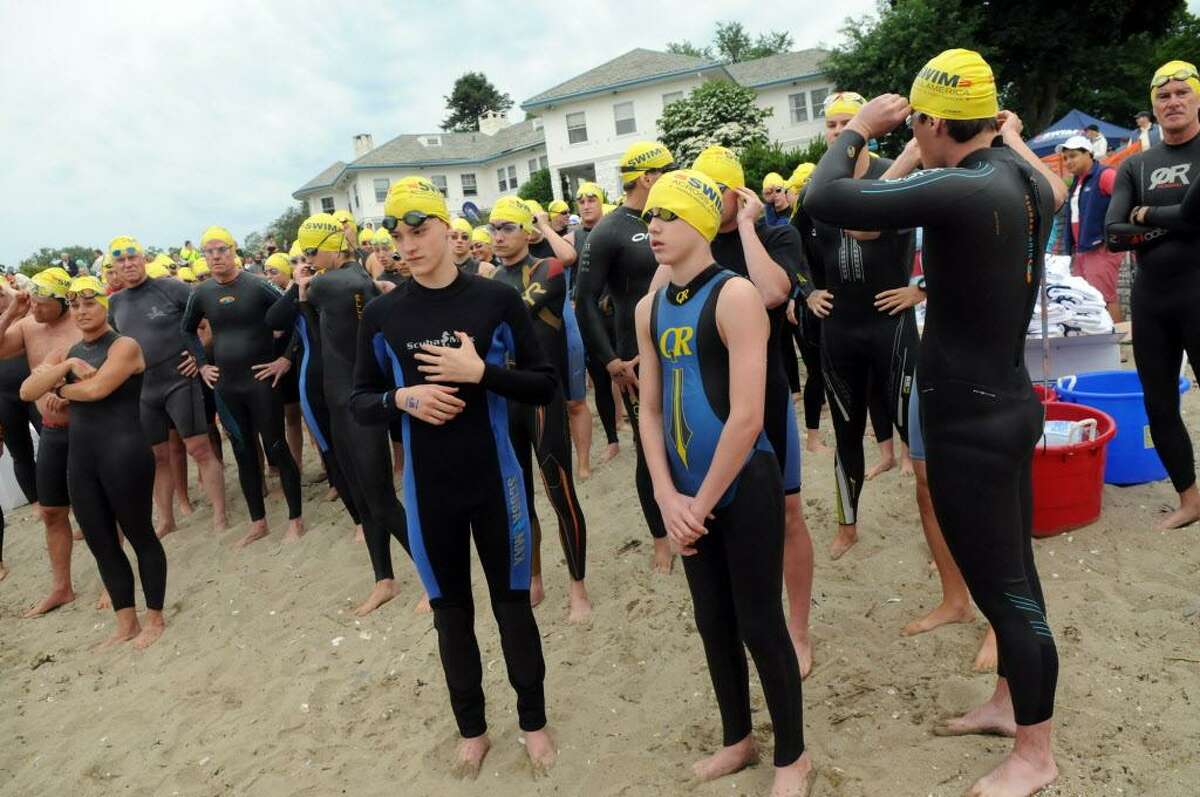 Swimmers wait to start as the 9th Annual Swim Across America Greenwich-Stamford takes place in the Sound along the border of Greenwich and Stamford at Cummings Point Road in Stamford, Conn., June 27, 2015. The funds raised by the event go to cancer gene therapy research.