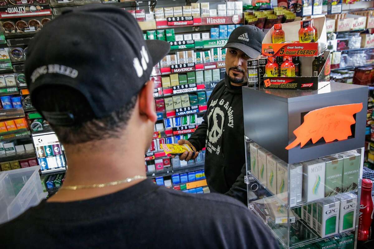 Store employee Majid Abbas (right) helps customer Alexander Maldonado buy flavored tobacco at City Smoke and Vape Shop in San Francisco, California, on Sunday June 11, 2017.