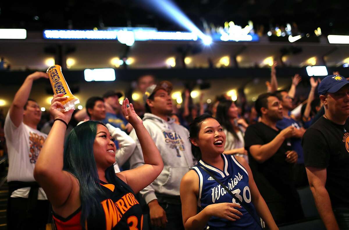 OAKLAND, CA - JUNE 09: Golden State Warriors fans watch a live broadcast of game four of the NBA Finals with the Cleveland Caveliers during a watch party at Oracle Arena on June 9, 2017 in Oakland, California. The Golden State Warriors missed a chance to be the first team in NBA history to have a record of 16-0 in the playoffs after they were beaten by the Cleveland Cavaliers by a score of 137-116. (Photo by Justin Sullivan/Getty Images)