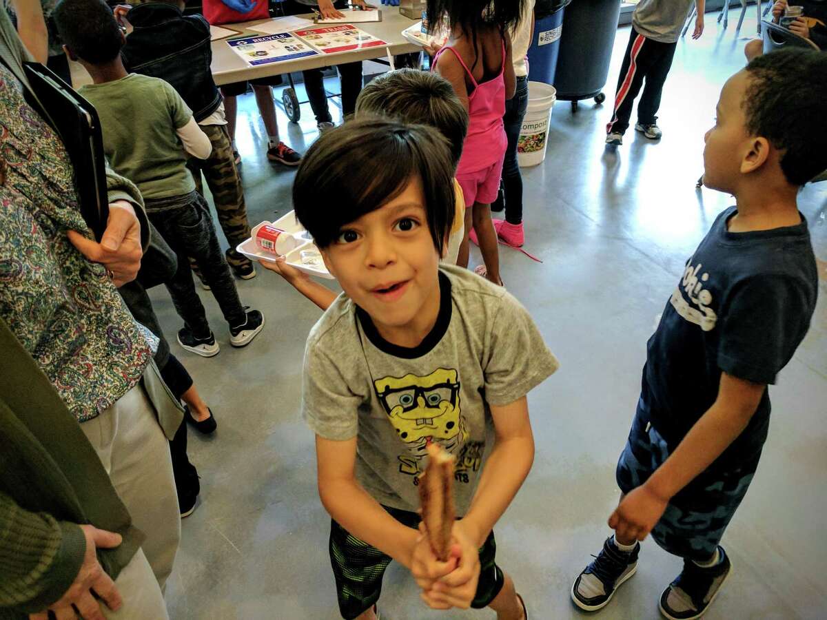 Theo Ho, 6, stands in line on the last composting weigh-in day of the school year at Hamilton Avenue School on June 10, 2017. He is ready to discard his pizza crust.