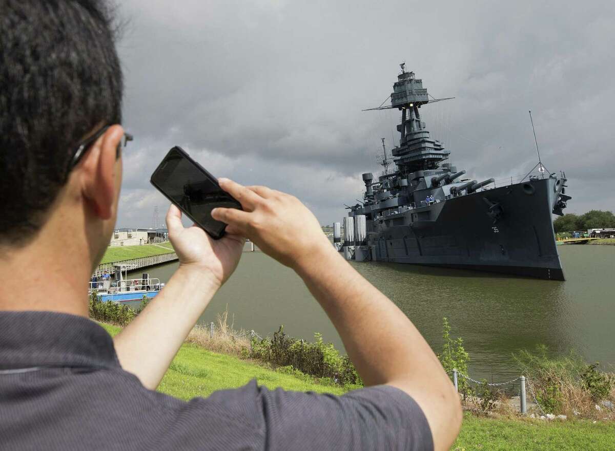 A man takes a photograph of Battleship Texas with his cellphone Monday in La Porte.