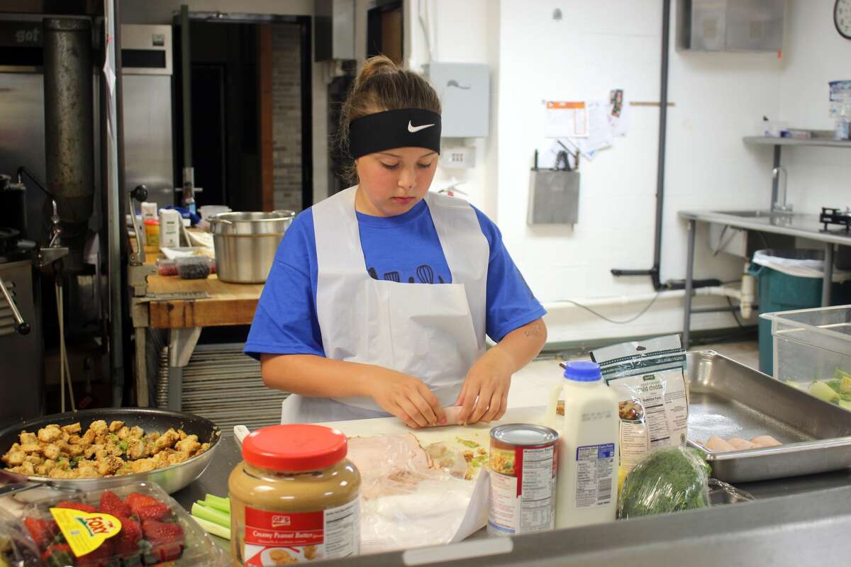 Laker cook-off contestant Hannah Helmuth prepares turkey rolls, stuffed with homemade stuffing and topped with cheese and creamy soup.