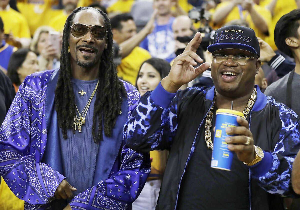 Musicians Snoop Dogg, left, and E-40 pose for photos before Game 5 of basketball's NBA Finals between the Golden State Warriors and the Cleveland Cavaliers in Oakland, Calif., Monday, June 12, 2017. (AP Photo/Marcio Jose Sanchez)