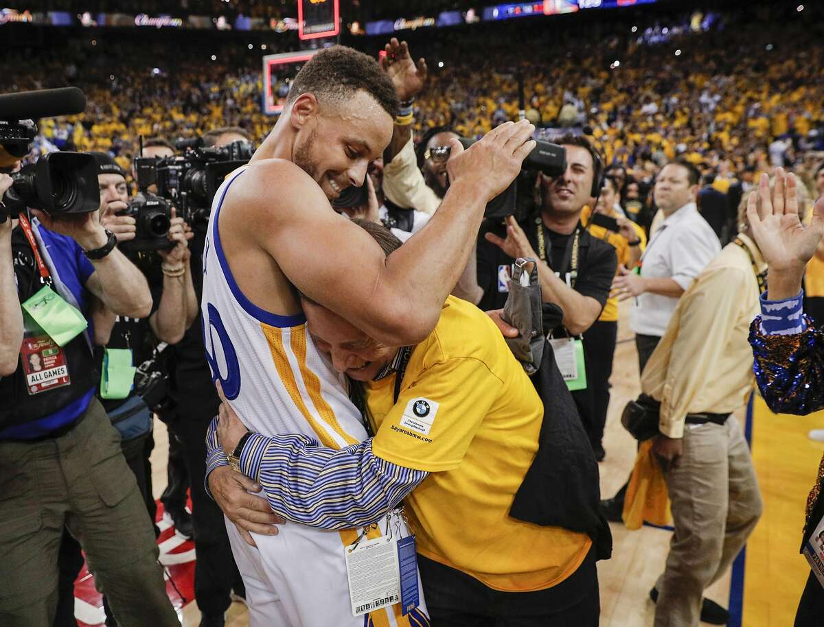 Golden State Warriors' Stephen Curry gets a hug from a fan after the Golden State Warriors defeated the Cleveland Cavaliers 129-120 during Game 5 to win the 2017 NBA Finals at Oracle Arena on Monday, June 12, 2017 in Oakland, Calif.