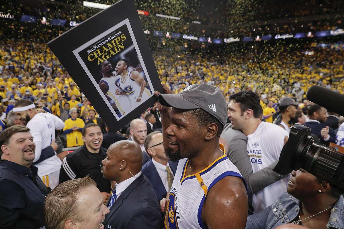 Golden State Warriors' Kevin Durant walks through the crowd after the Golden State Warriors defeated the Cleveland Cavaliers 129-120 during Game 5 to win the 2017 NBA Finals at Oracle Arena on Monday, June 12, 2017 in Oakland, Calif.