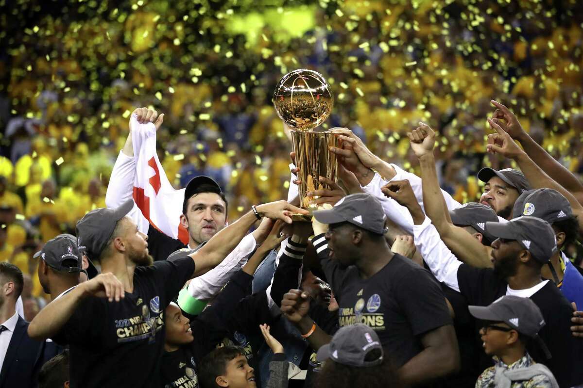 The Warriors get their hands on the Larry O'Brien Championship Trophy after the Cavaliers and their Cleveland fans had it for a year.