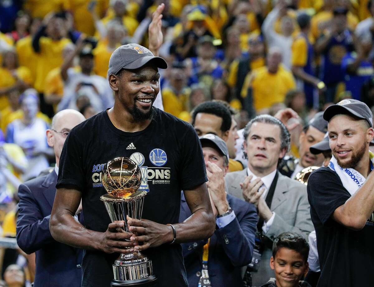 Golden State Warriors' Kevin Durant holds the The Bill Russell MVP Award after Game 5 of the 2017 NBA Finals at Oracle Arena on Monday, June 12, 2017 in Oakland, Calif. The Golden State Warriors defeated the Cleveland Cavaliers 129-120 to win The Finals.