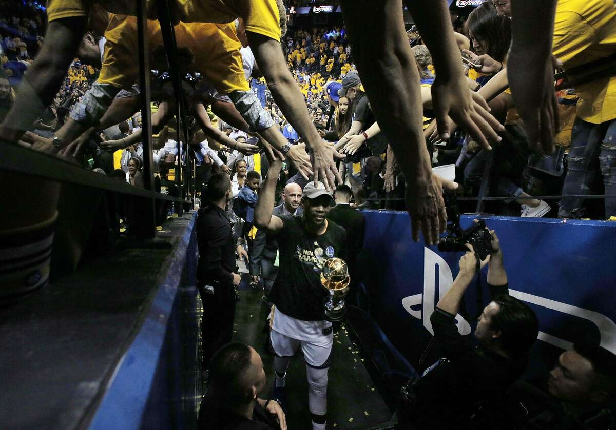 Fans high five Kevin Durant as he walks toward the locker room after Golden State Warriors defeated the Cleveland Cavaliers 129-120 in Game 5 of the NBA Finals at Oracle Arena in Oakland, Calif., on Monday, June 12, 2017, to become NBA Champions for the second time in three years.