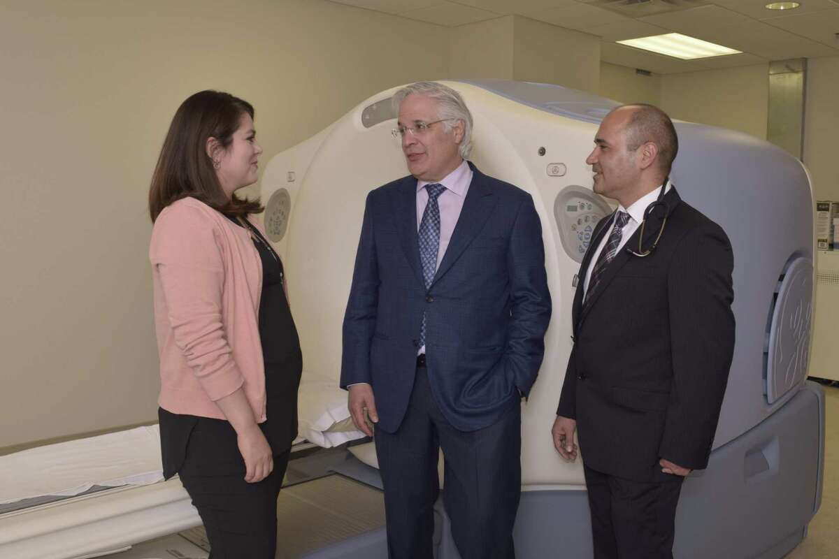 Dr. Ricardo Cigarroa, interventional cardiologist, speaks with Dr. Mohsen Mahani, medical oncologist, and Dr. Selina Stuart, hematologist oncologist, about the benefits the PET scanner offers cancer patients through exams that can now be done locally.