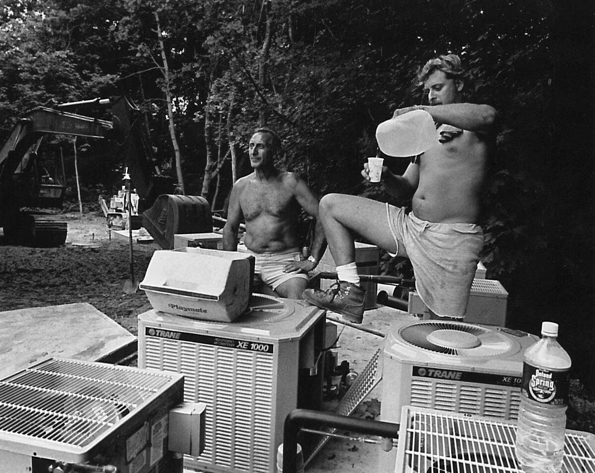 From left: Ben Ianni and Rob Ianni cool off among air conditioning units at a Department of Housing and Urban Development construction site at 50 Brookside Drive Greenwich on Aug. 28, 1992.