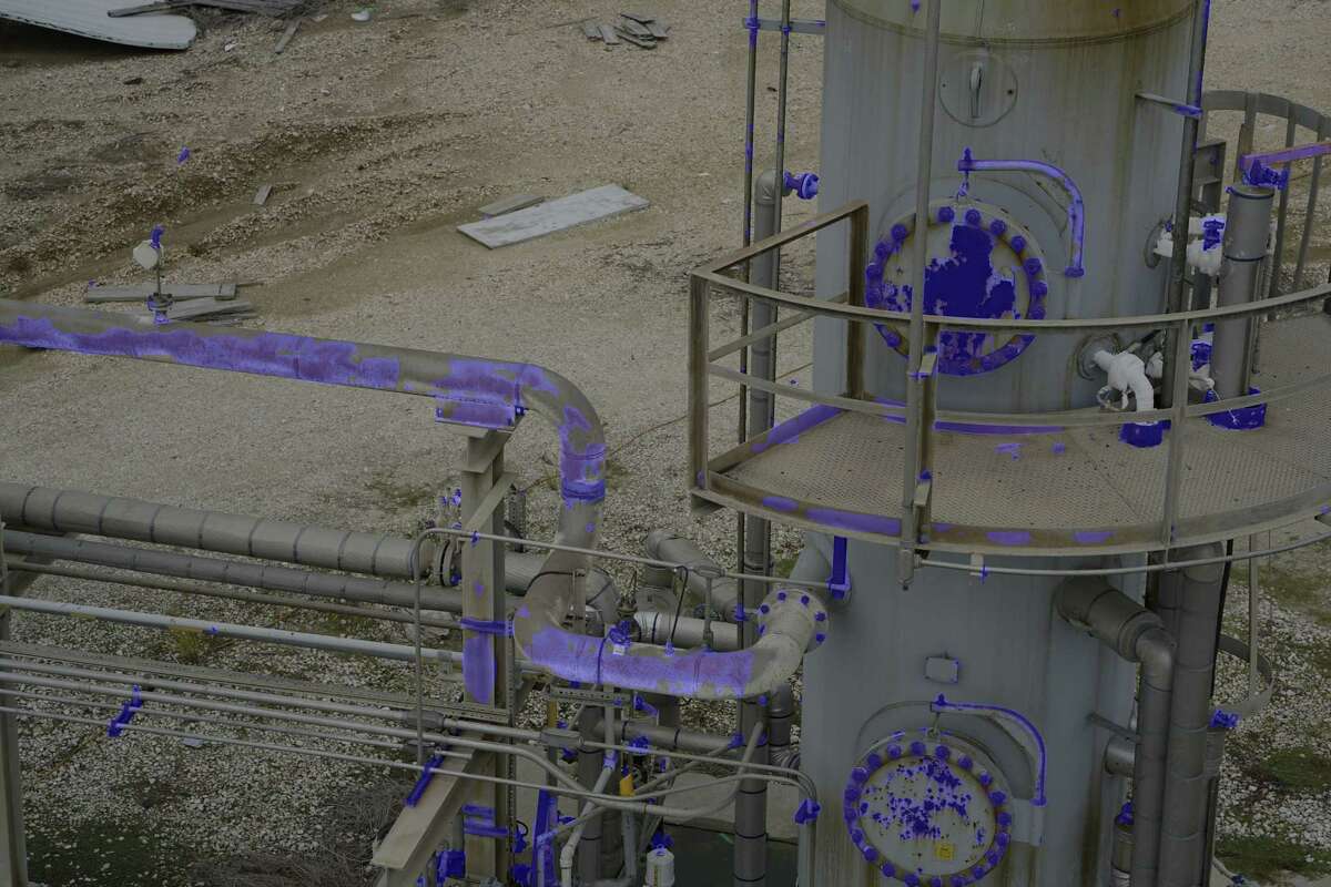 A photo of of oil and gas piping taken by a GE drone. The blue color represents corrosion detection.