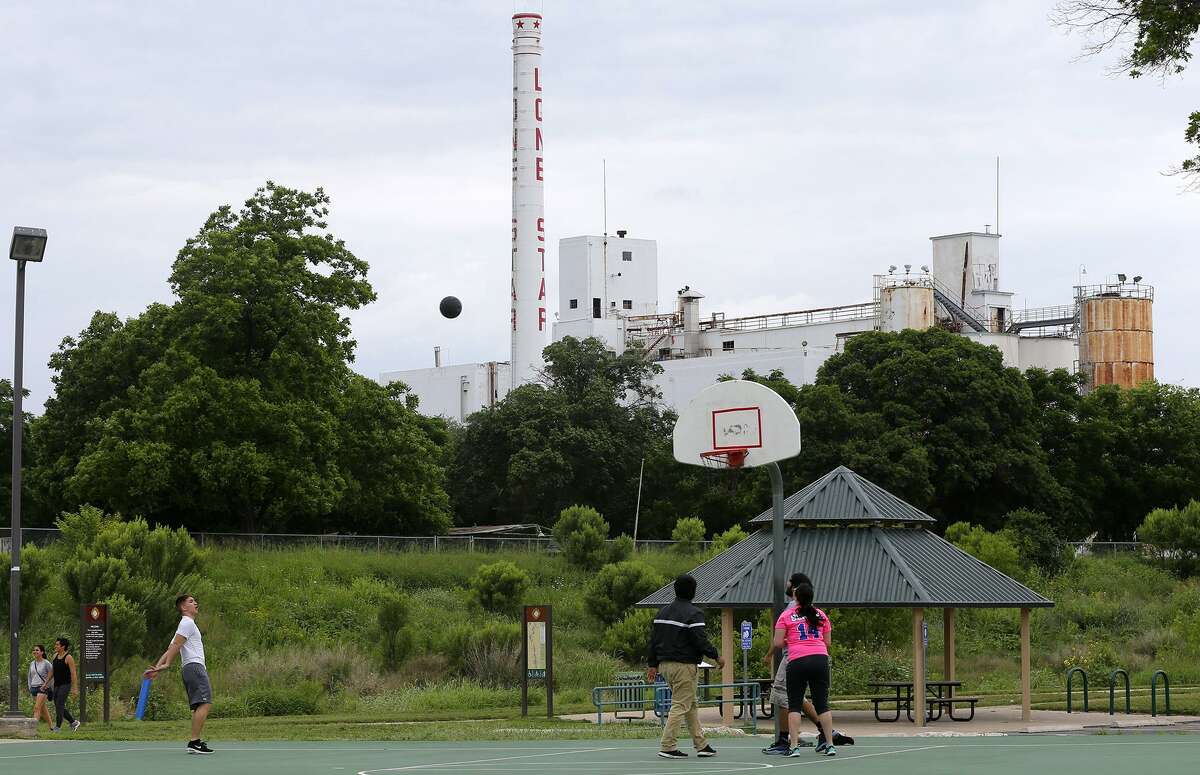 People play basketball Tuesday May 5, 2015 near the old Lone Star brewery. The property has sat unused since closing in 1996. The property is located between the San Antonio River and Newell Recycling.