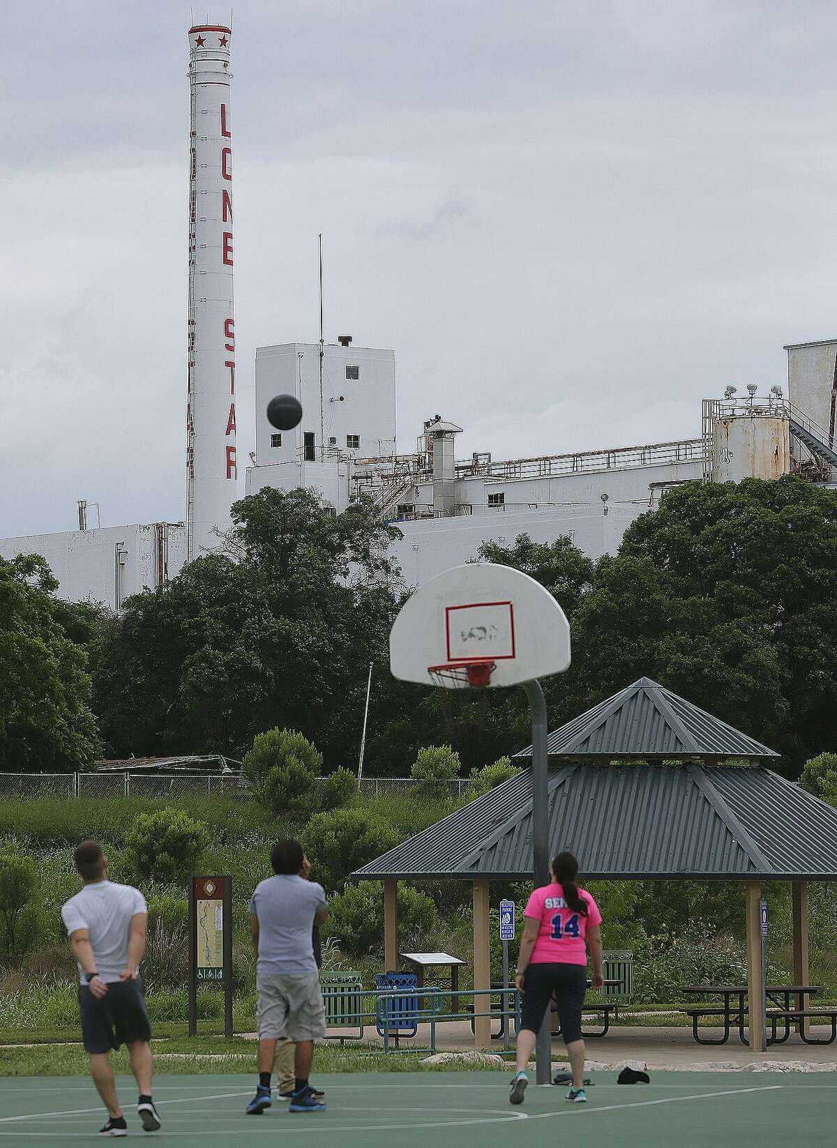 People play basketball Tuesday May 5, 2015 near the old Lone Star brewery. The property has sat unused since closing in 1996. The property is located between the San Antonio River and Newell Recycling.