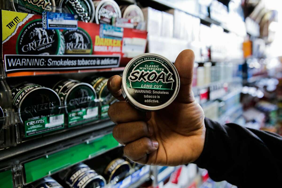 Employee Majid Abbas shows off a package of flavored tobacco at City Smoke and Vape Shop in San Francisco, California, on Sunday June 11, 2017.