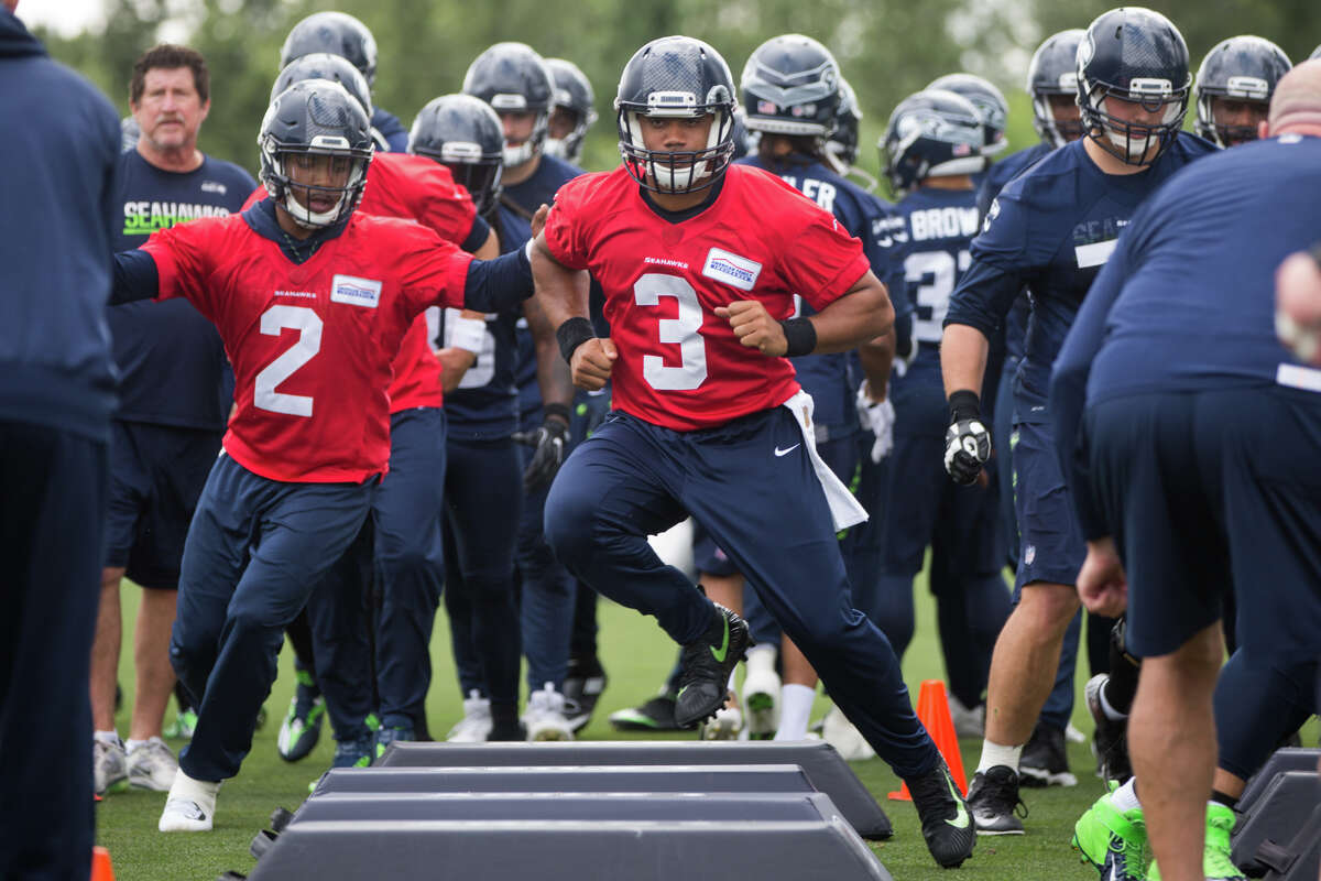 Seahawks quarterback Russell Wilson runs an agility drill during Seahawks minicamp on Tuesday, June 13, 2017.